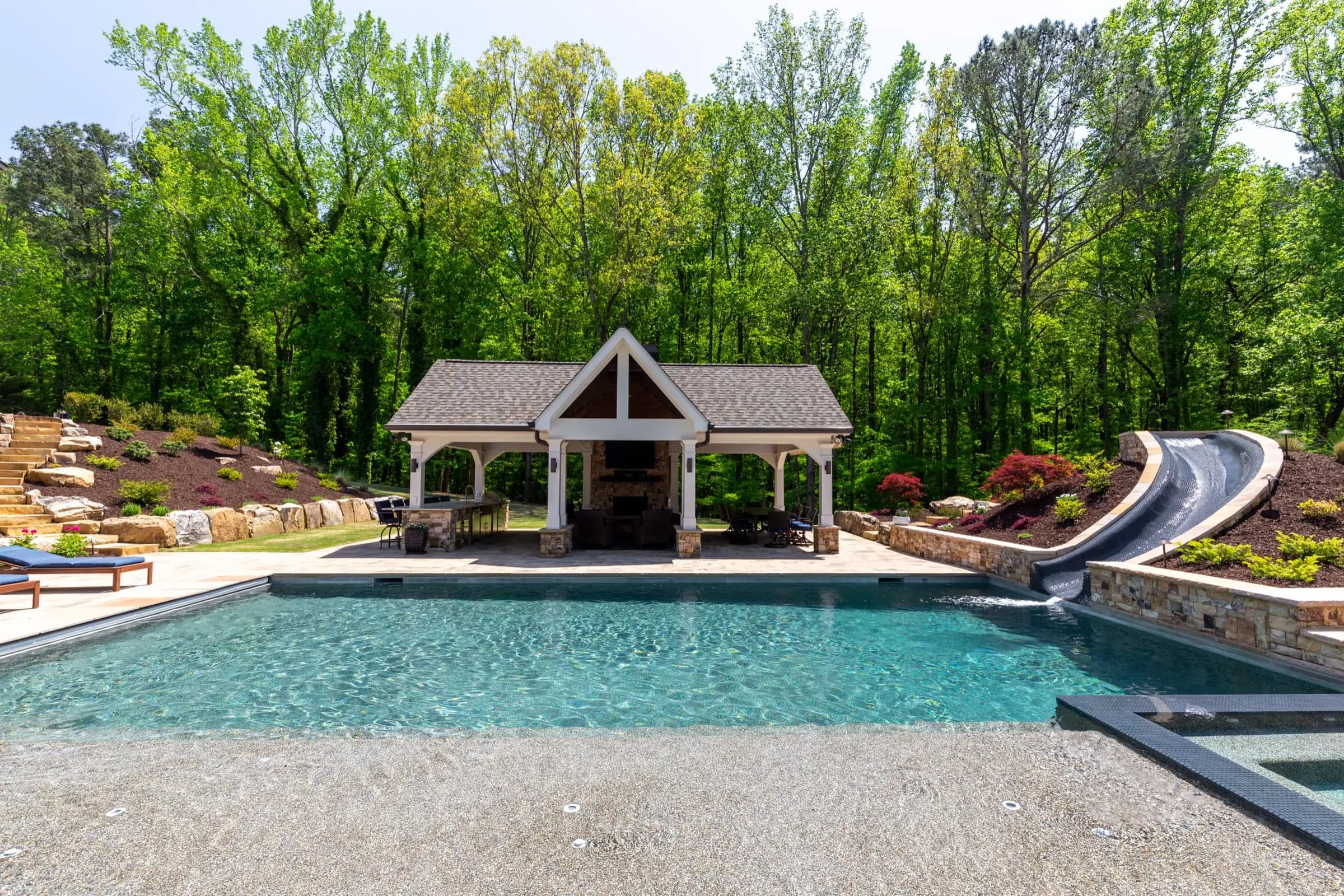 The Batchelor pool and covered pavilion in Roswell, with the water slide built into stone at one edge