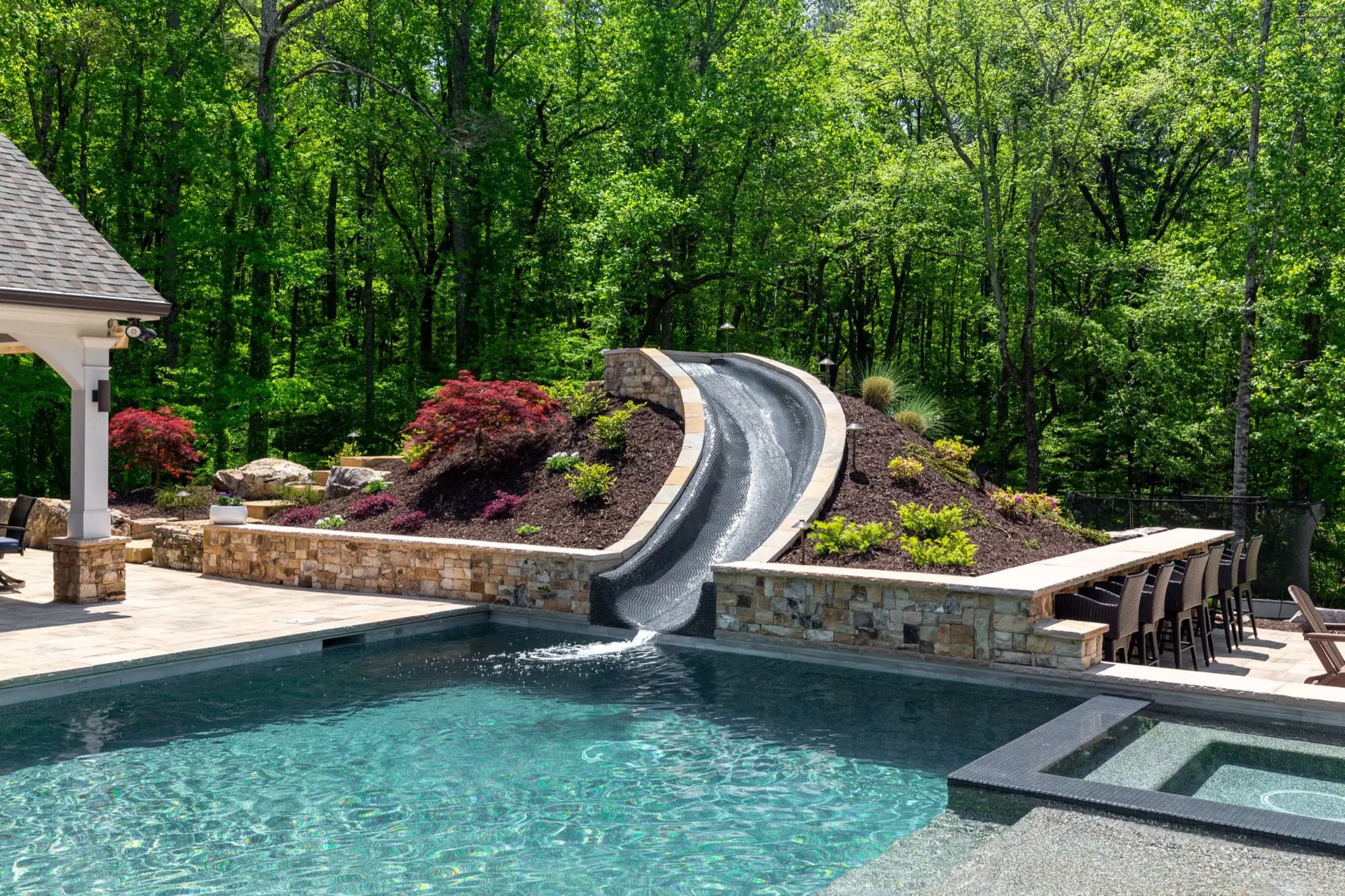 The water slide at the Batchelor project in Roswell, set into planted stone beside the pool