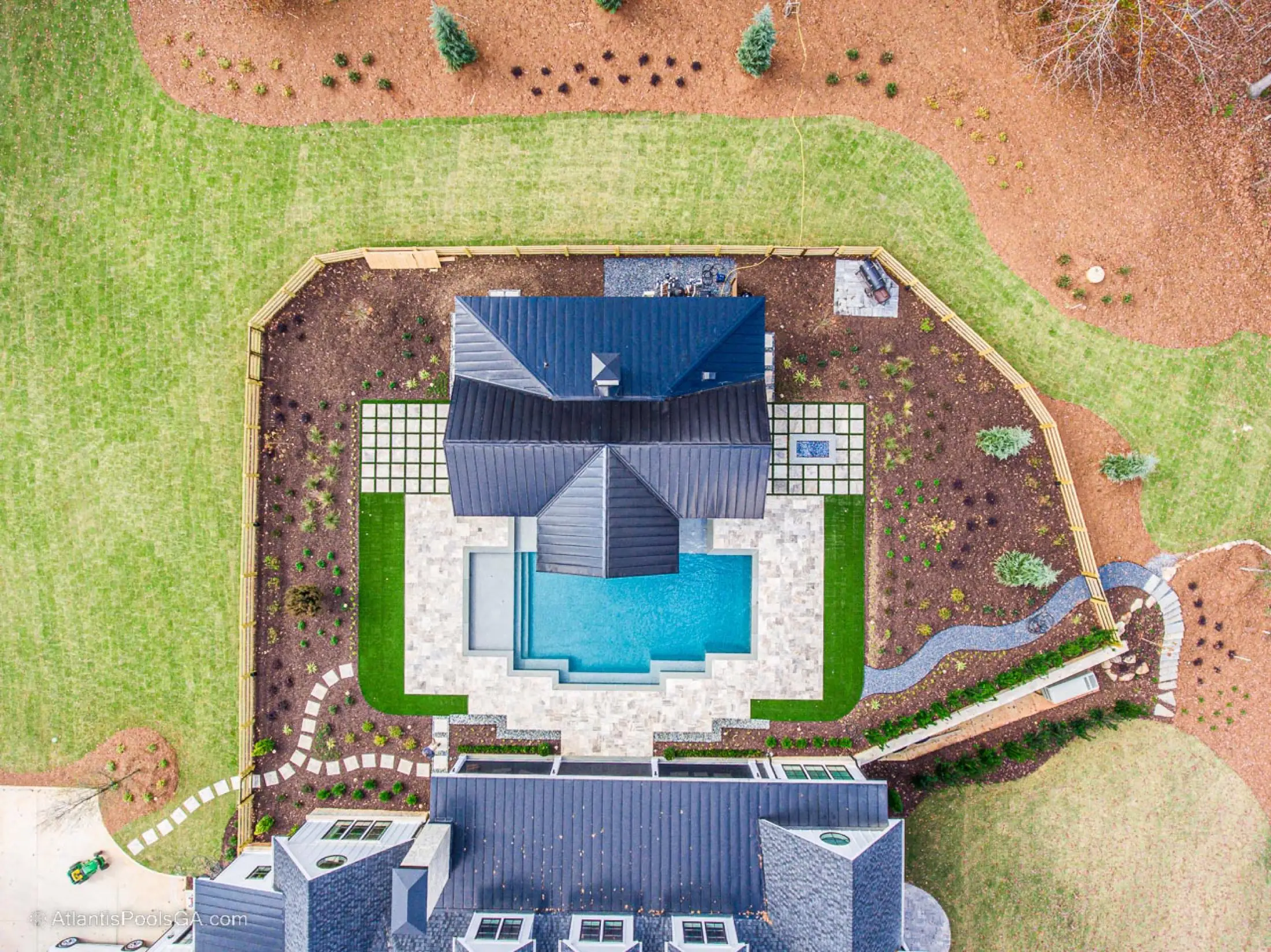 Aerial view over the Bolduc pool and pavilion, showing the full hardscape and outdoor living layout