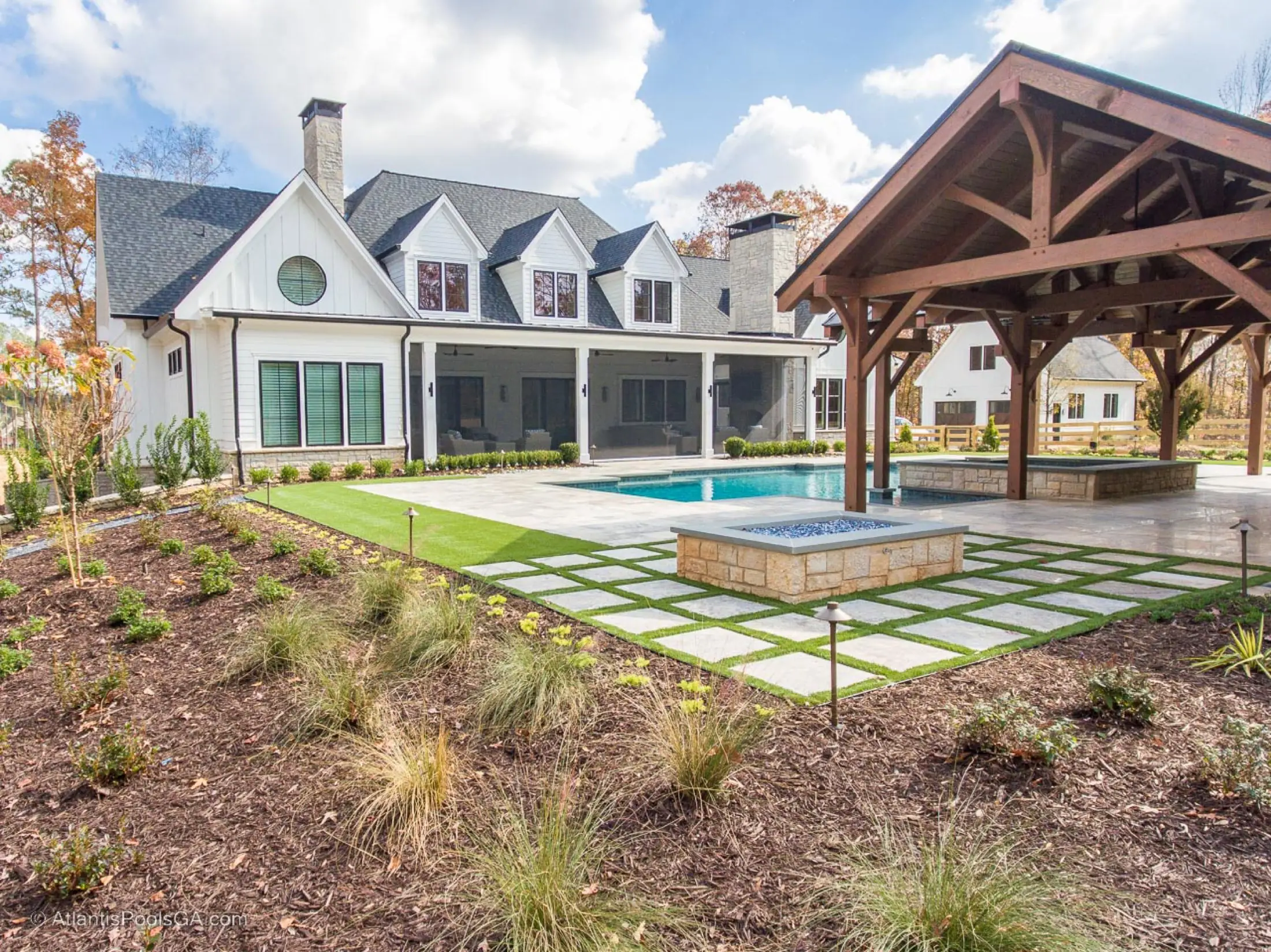 Wide view of the Bolduc pool, house, and covered pavilion