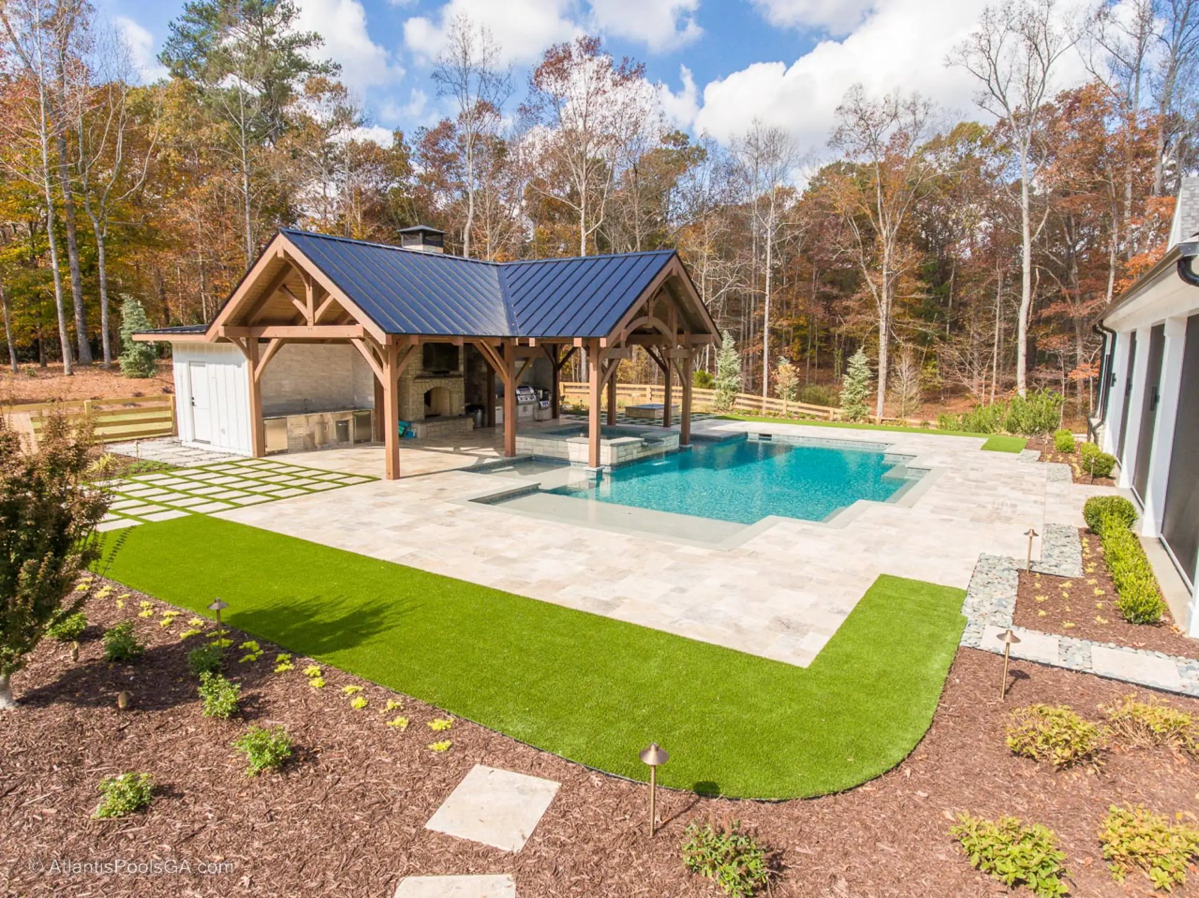 The Bolduc pool and covered pavilion, a wide view across the backyard