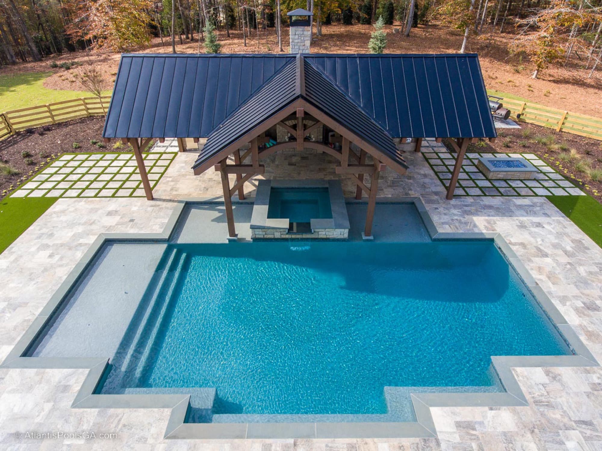 The Bolduc pool beside its covered pavilion and modern farmhouse