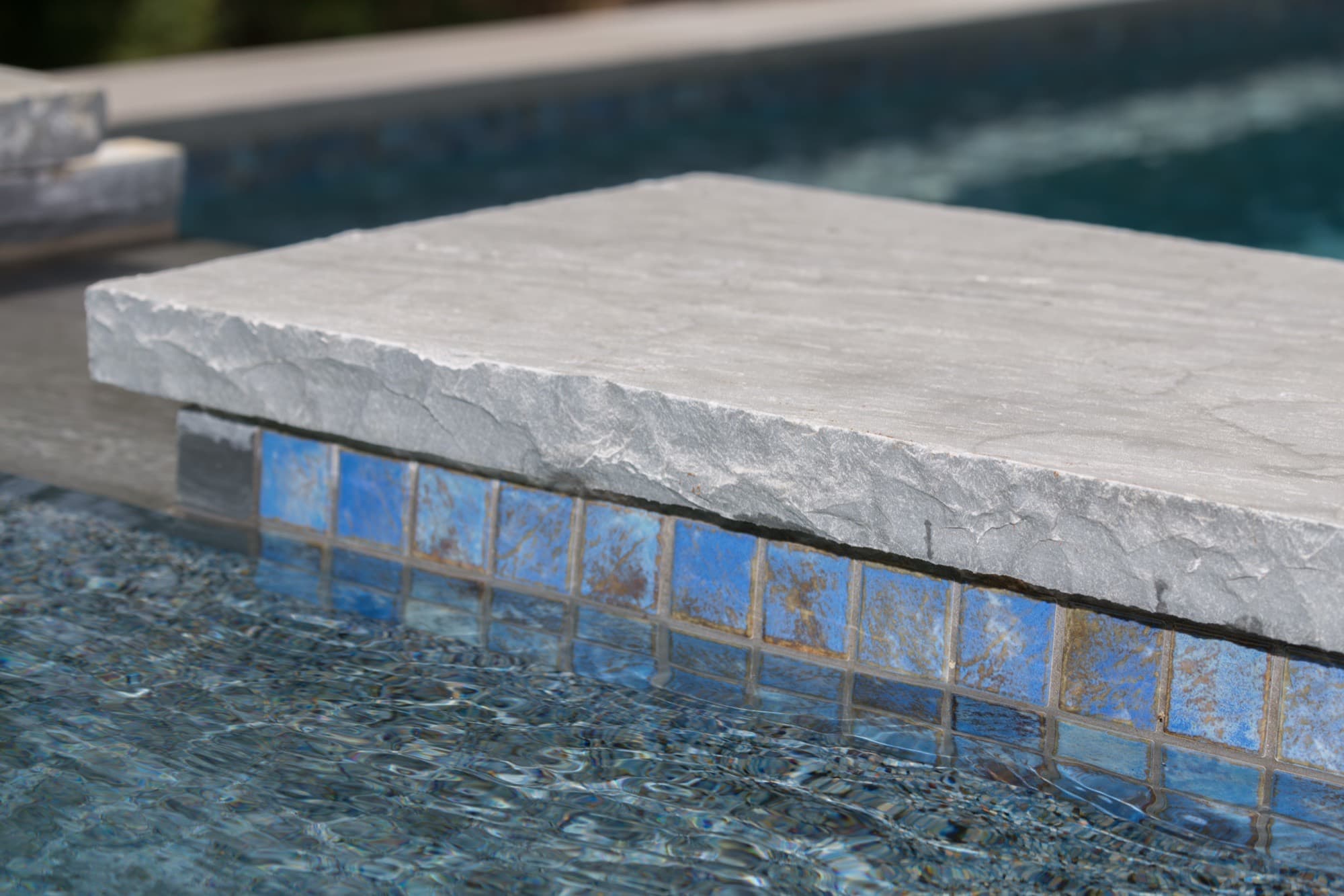 Rebuilt coping and edge detail around a renovated pool.