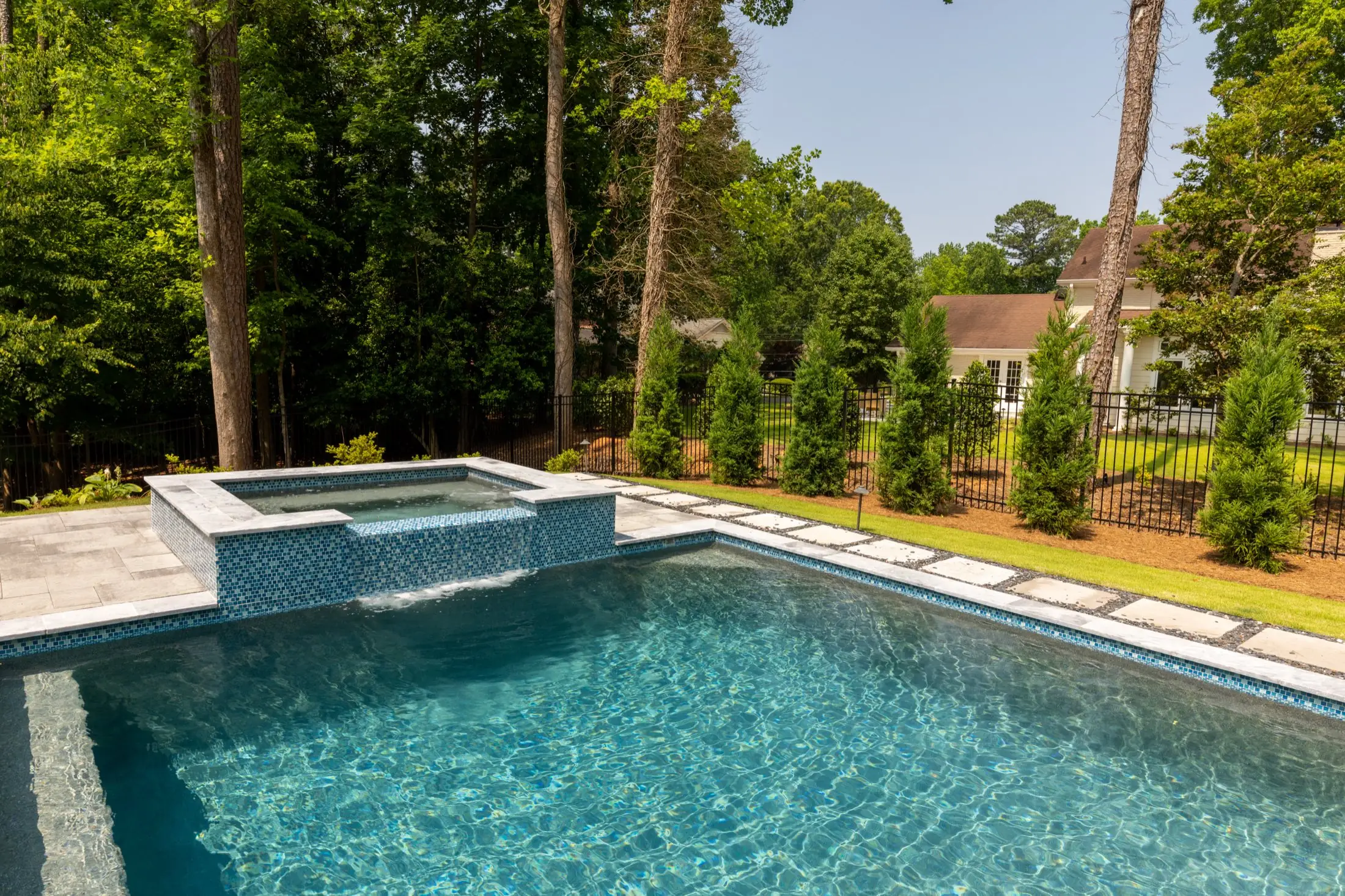 The Goldstein raised spa in Dunwoody built into a custom pool design, an example of Atlantis's spa and water feature work