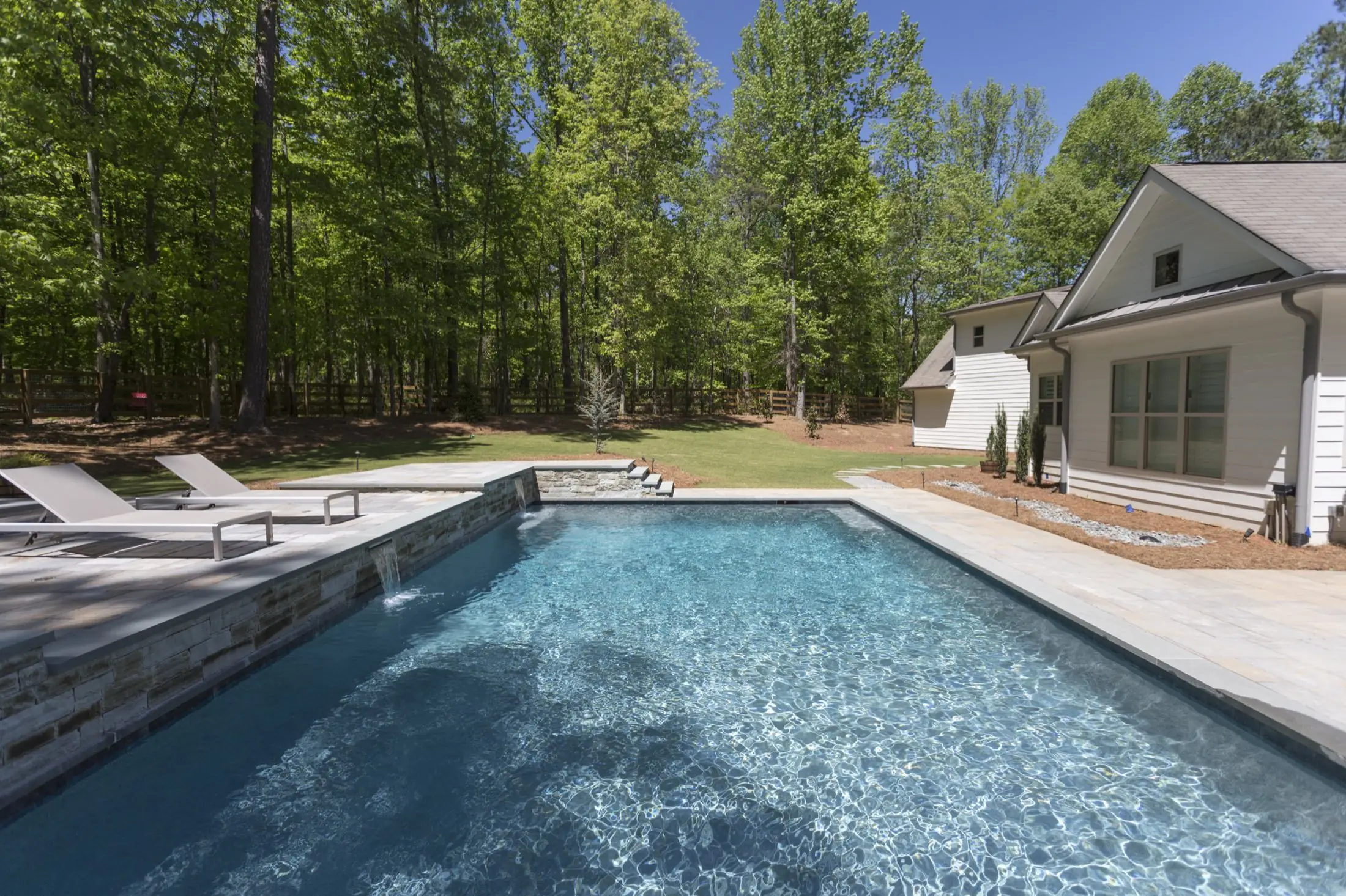 Wide view of the Nichol pool in Canton, a long straight run of water stretching toward the house