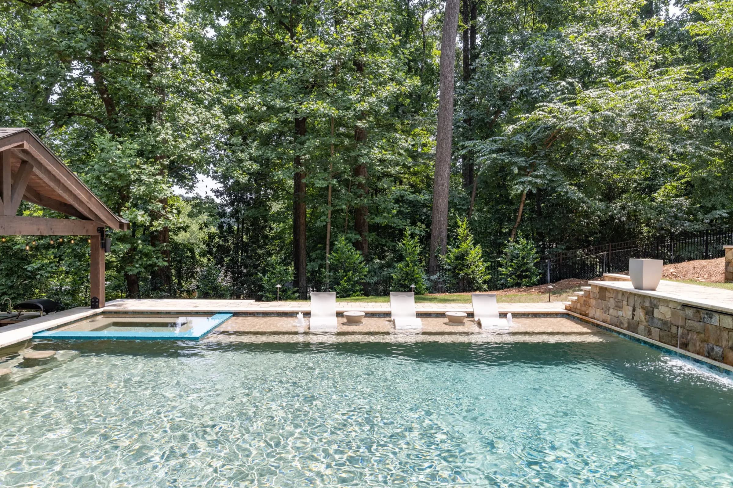 A pool and spa built as one connected water feature, part of a full outdoor living environment.