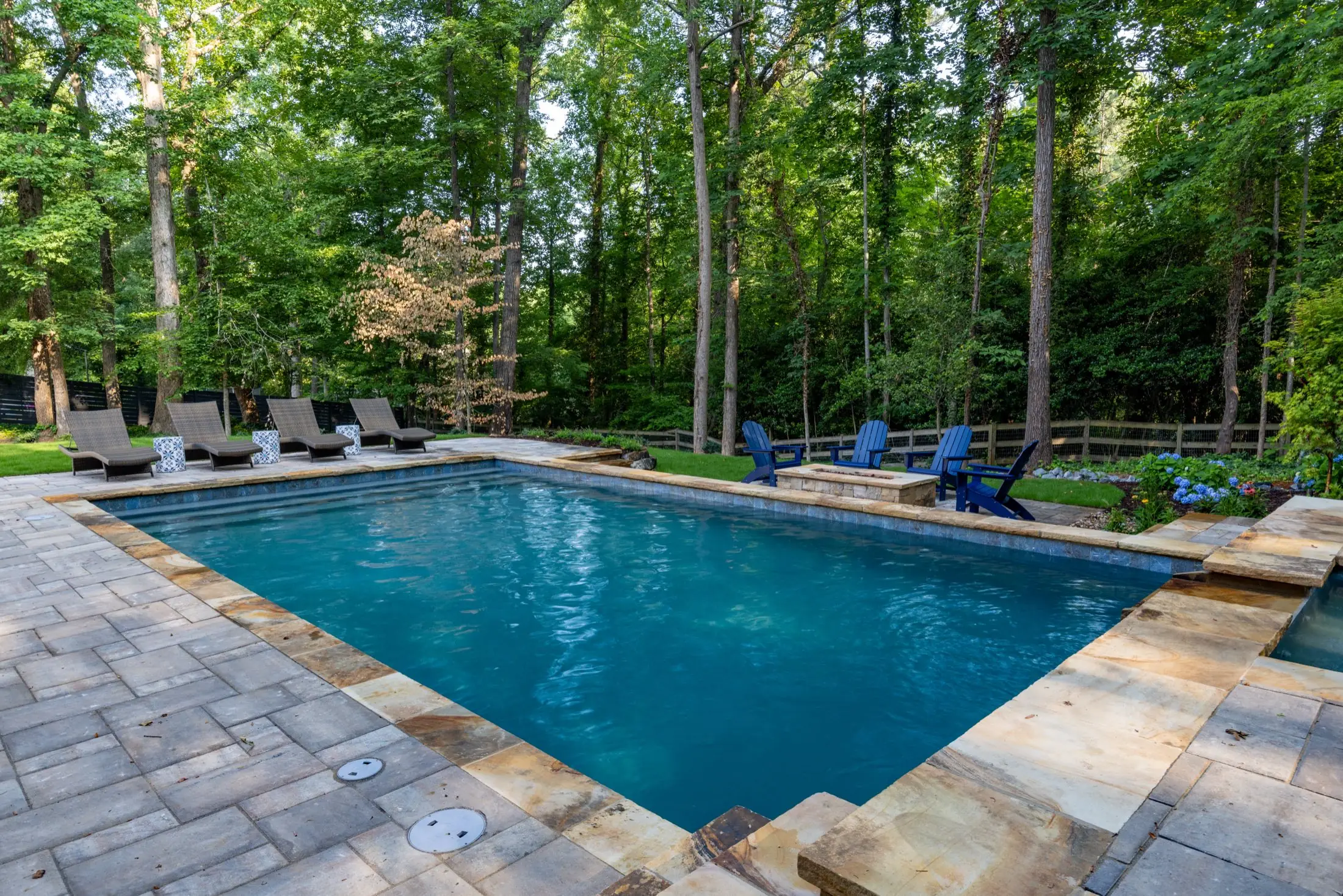 The Wang project in Dunwoody, a long pool framed by mature trees